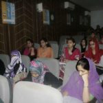 Small theatre-style classroom filled with women
