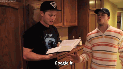 Gif of guy reading book, another guy slapping it away, saying Google It