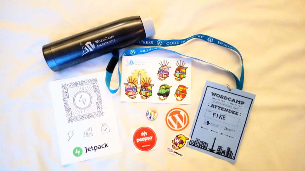 WordCamp swag spread out on a surface.