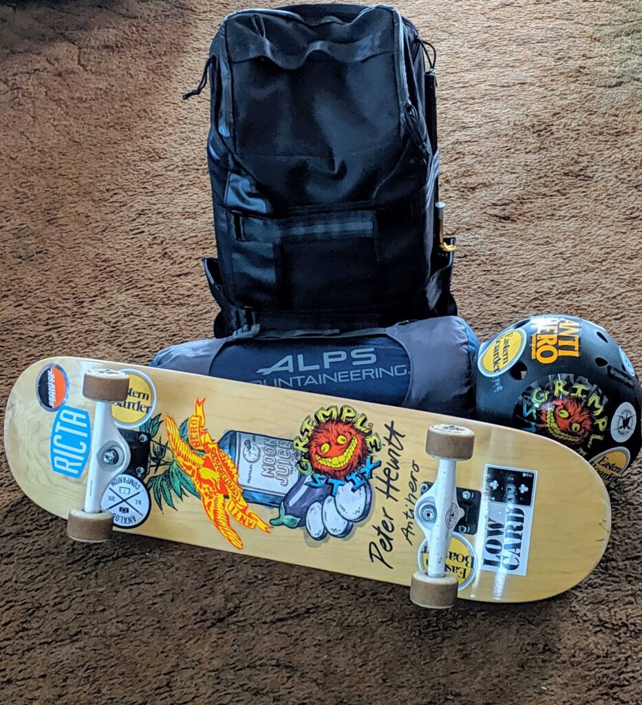 A backpack, helmet, tent, and skateboard.