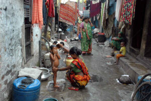 Child being bathed in an alley in Kolkata